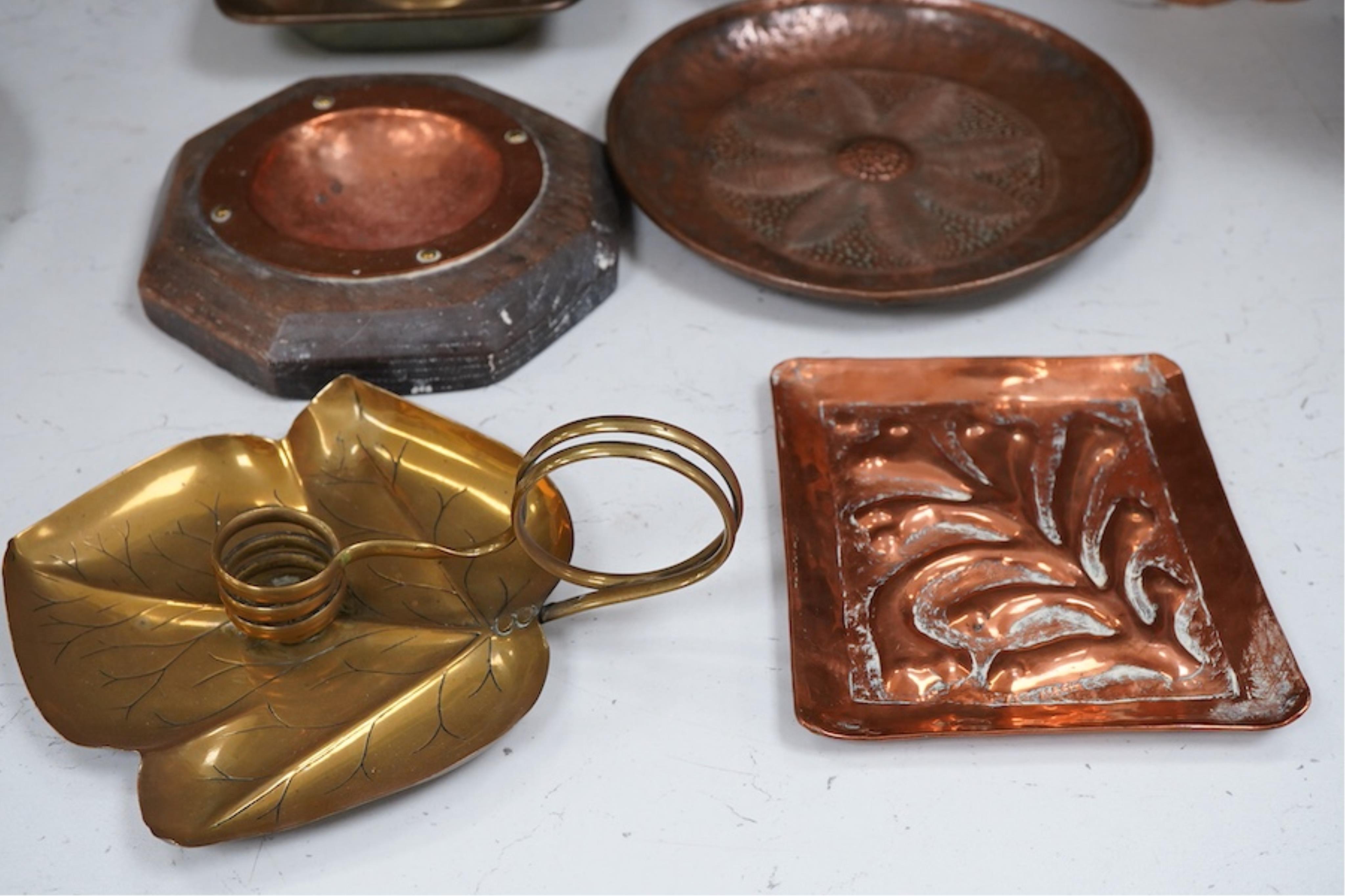 A group of brass and copper Arts & Crafts vases, including a J Sankey leaf candle holder